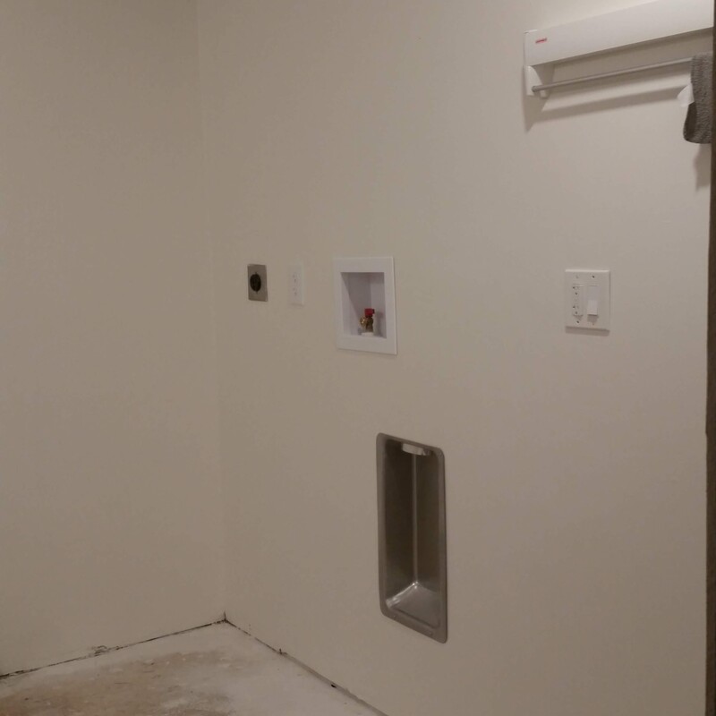 The fixtures were adjusted to move the washer left of the dryer for easier laundry transitions.